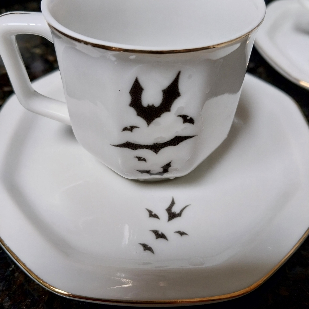 White Teacup and Saucer with Black Bat Design